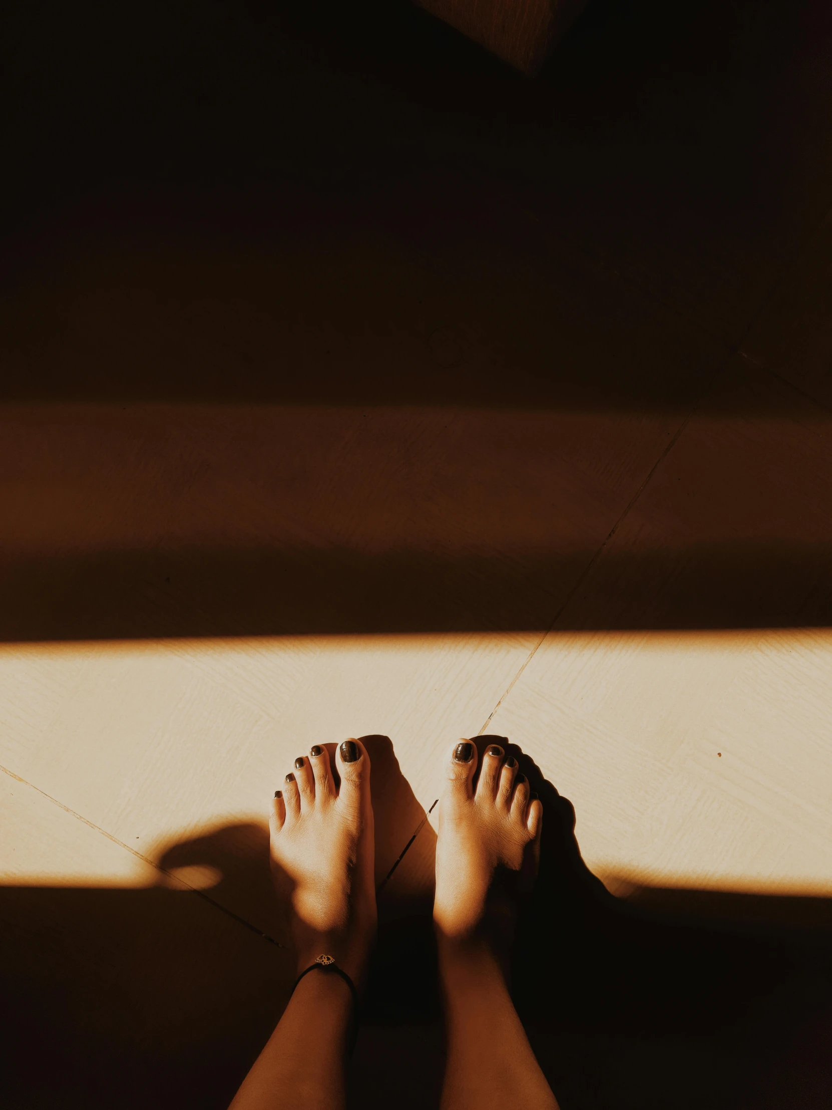 the foot and body of a person casting a shadow