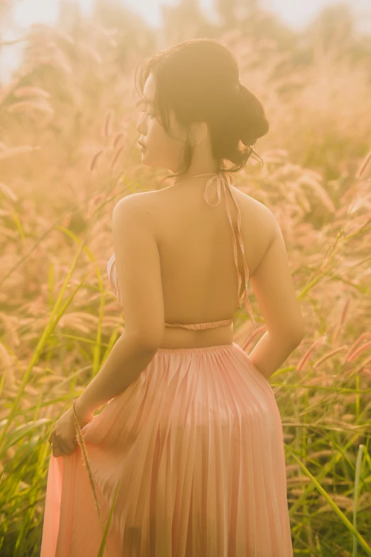 a woman standing in a field with grass