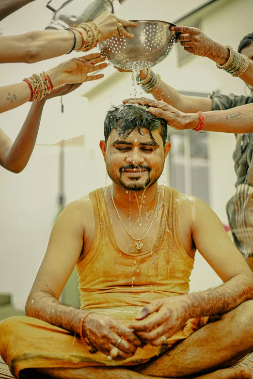 men in religious garba being wash by the gods