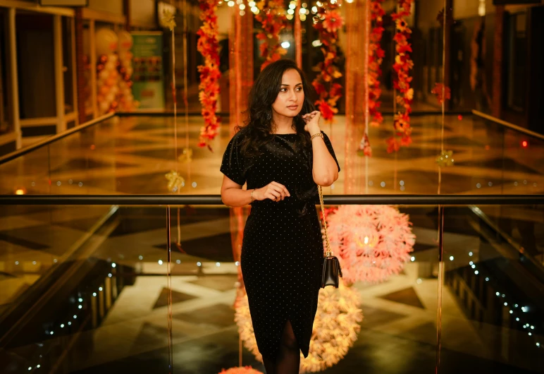 a woman is standing in front of a large mirror