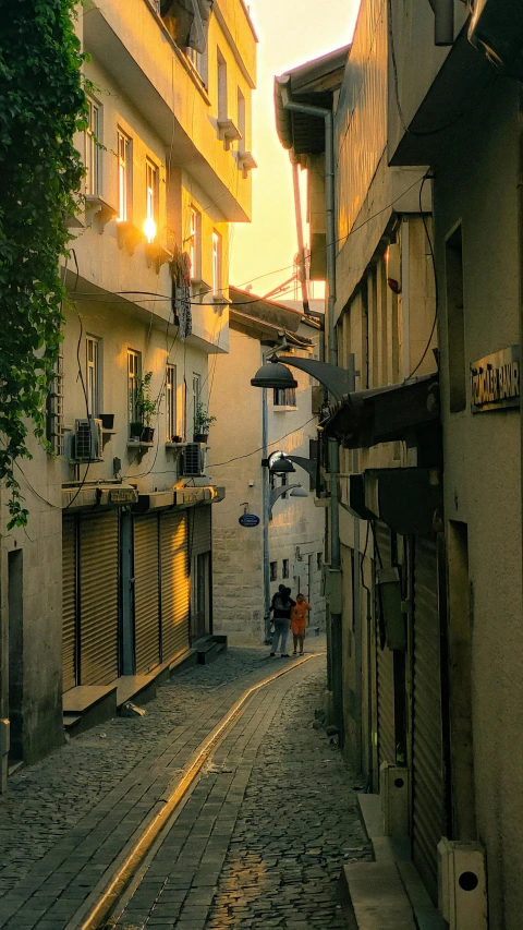 a person stands on a street between buildings