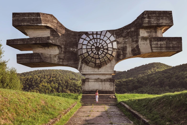 a statue is shown with a large wheel and faces in the middle