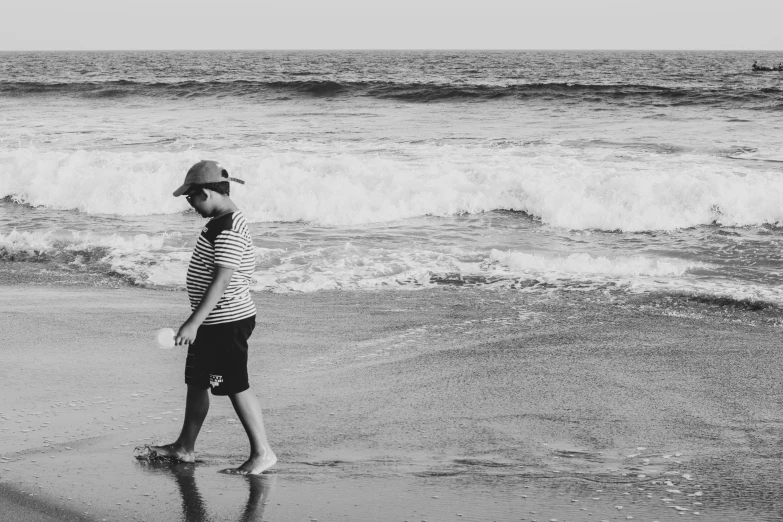 a person walking on the beach next to the ocean