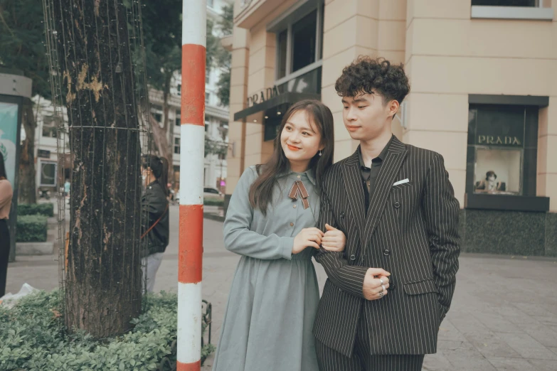 two people standing in front of a street sign