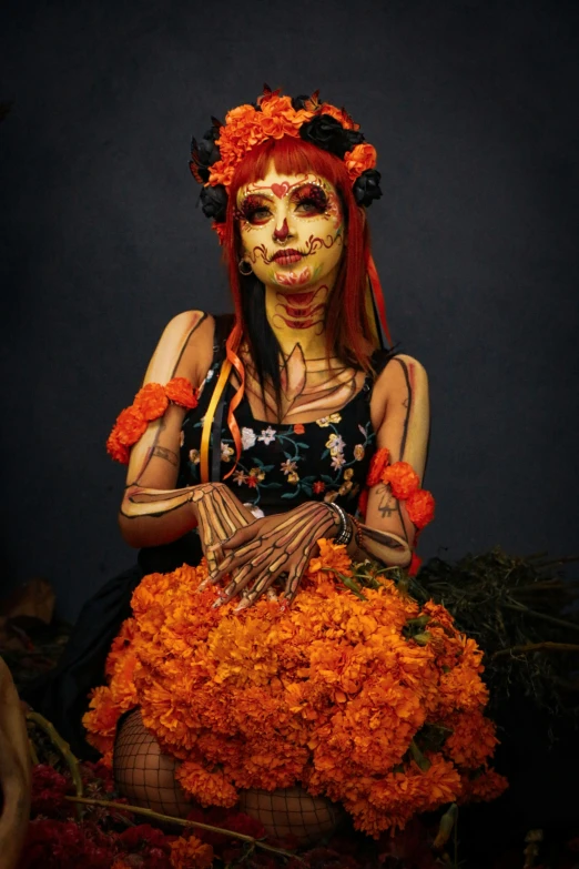 a woman in skeleton makeup with flowers in her hands