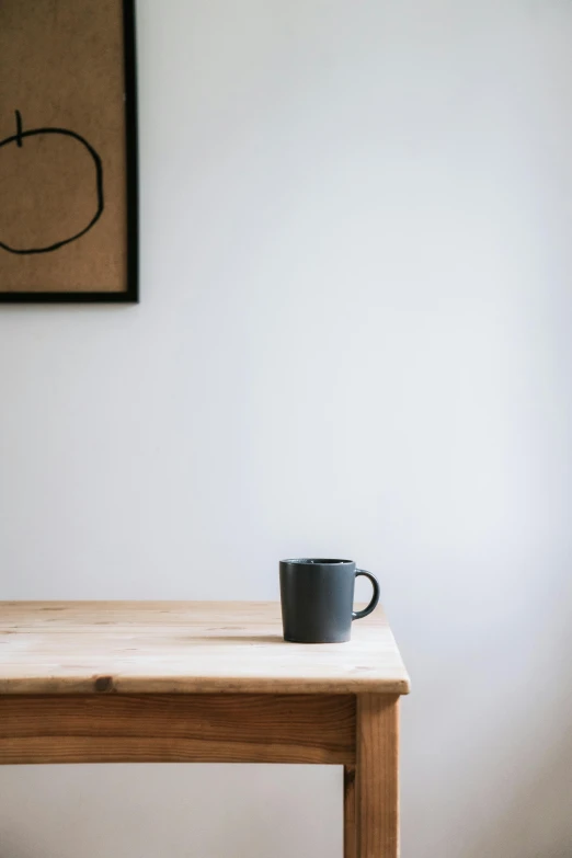 a coffee cup sitting on top of a wooden table