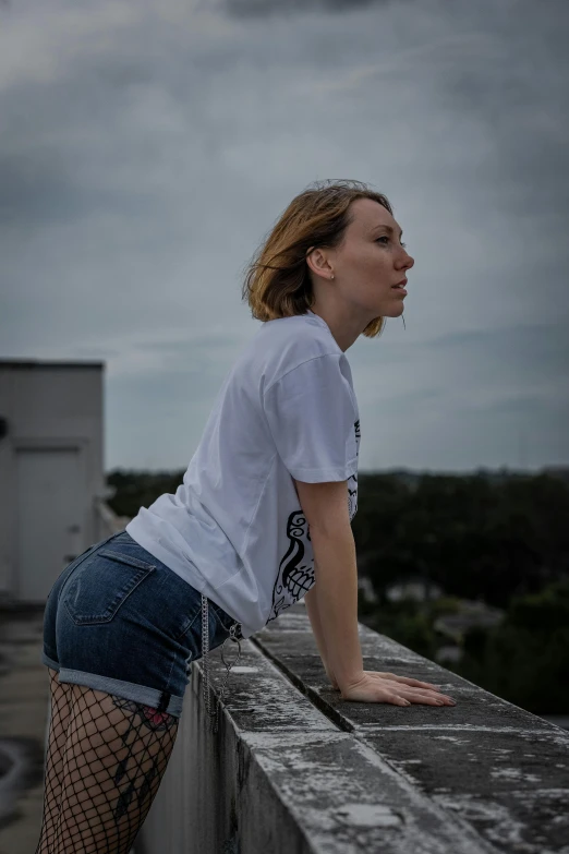 a woman leaning on the roof of a building