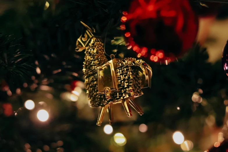 the ornaments on the christmas tree are shiny gold