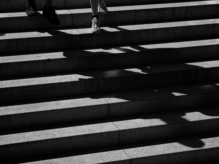 people walking across a crosswalk under an umbrella