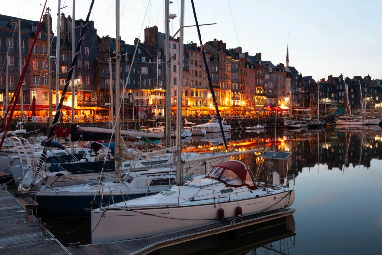 a harbor with several boats and some buildings in the background