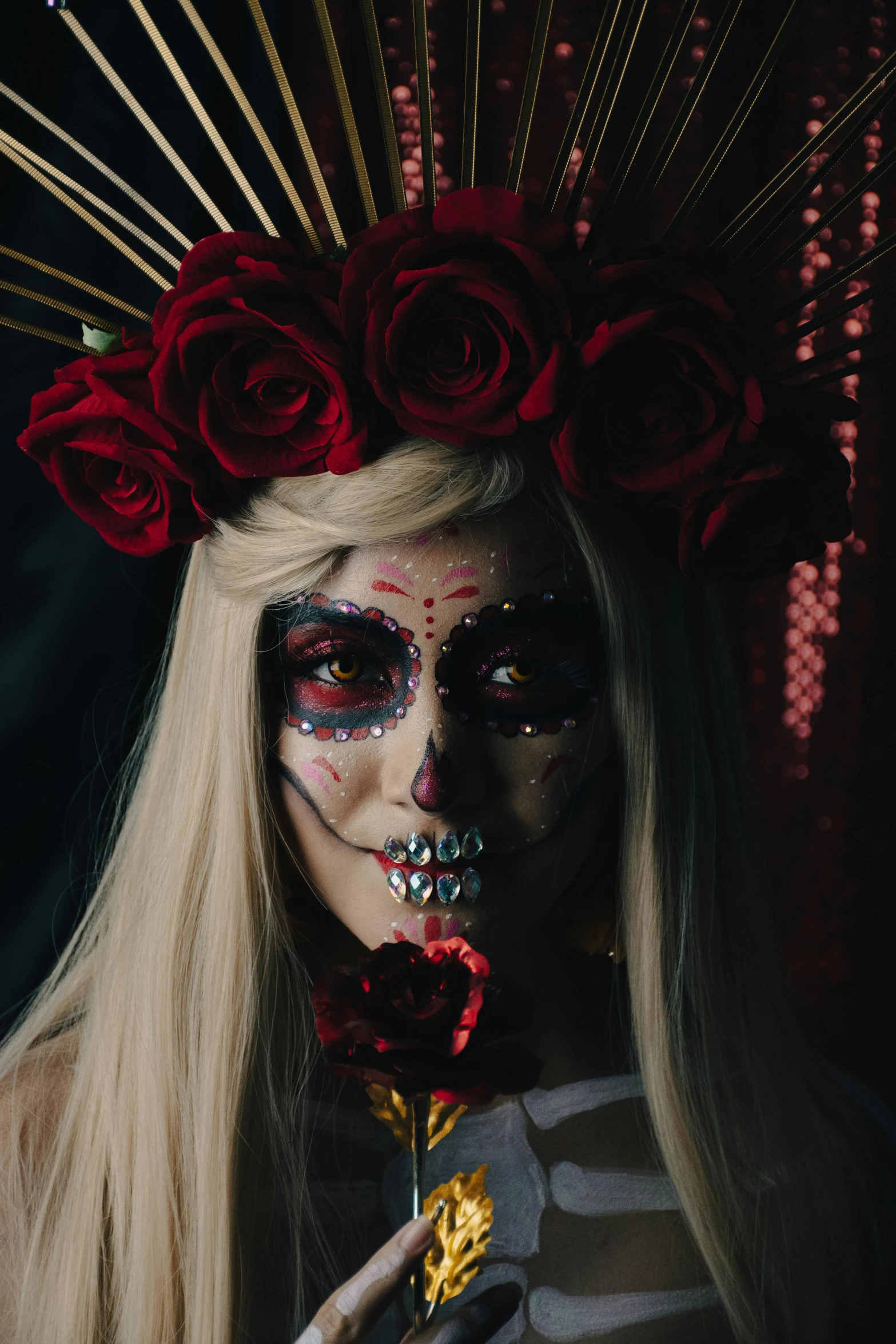 a person with black and white makeup and flower decorated hat