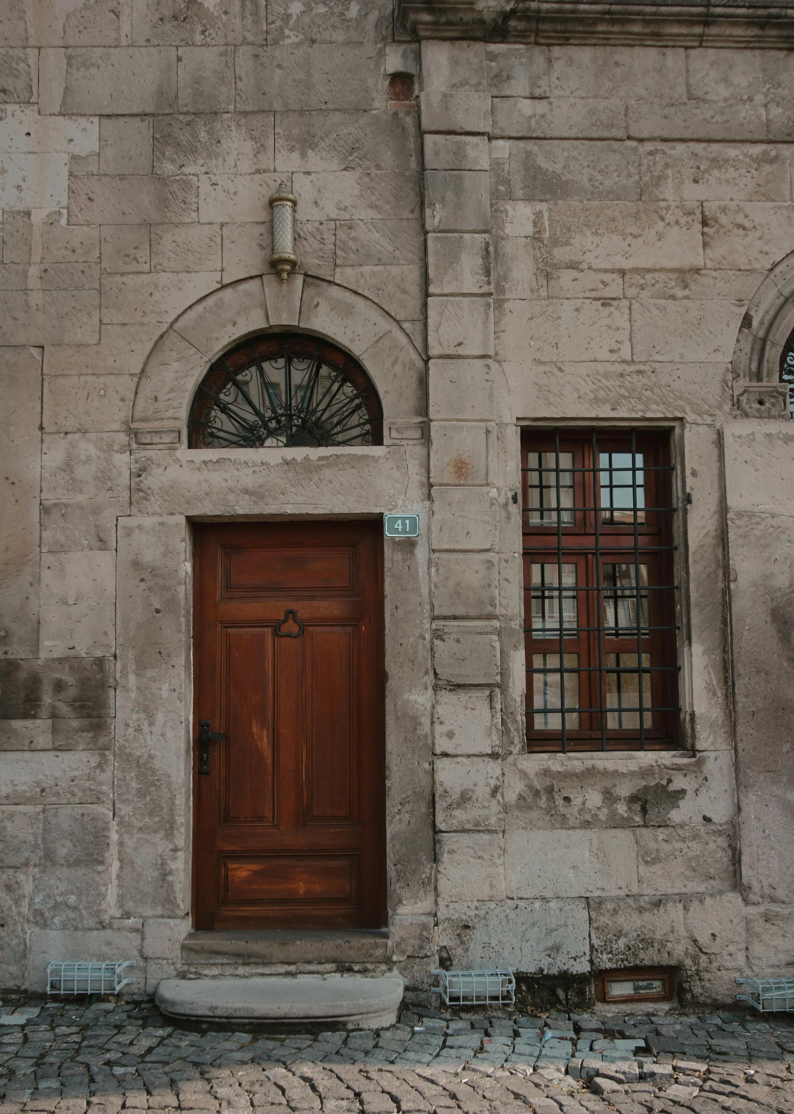 a brick building with two wood doors and windows