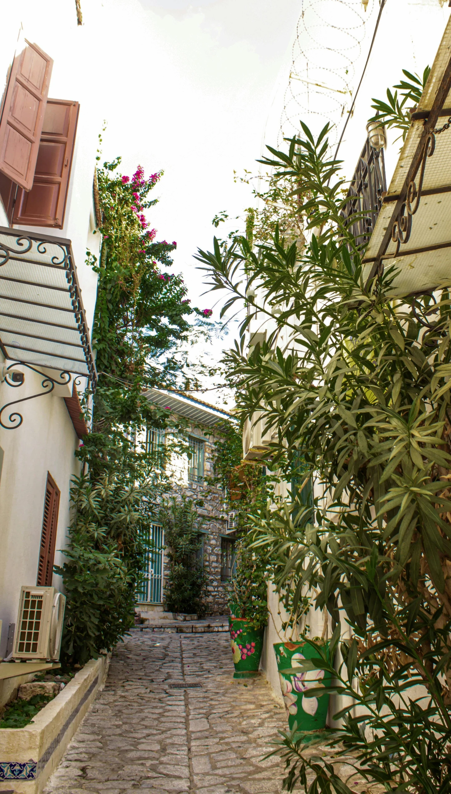 an alleyway leads through a small town with small houses on either side