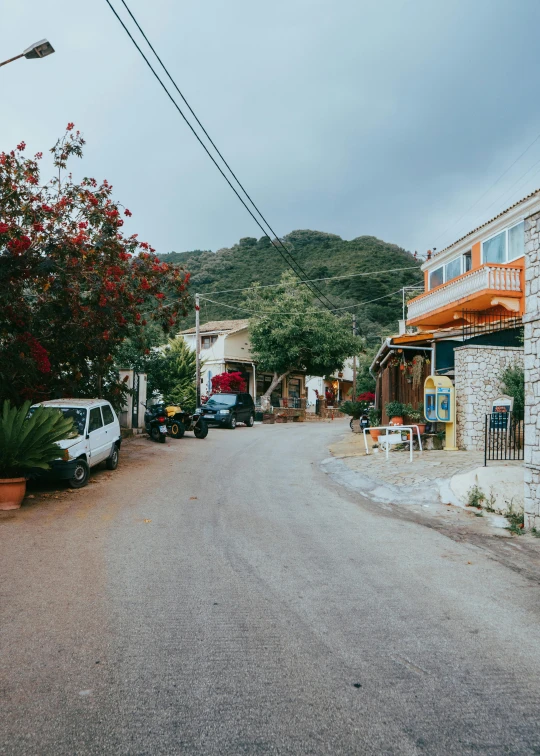 a road is lined with cars and flowers