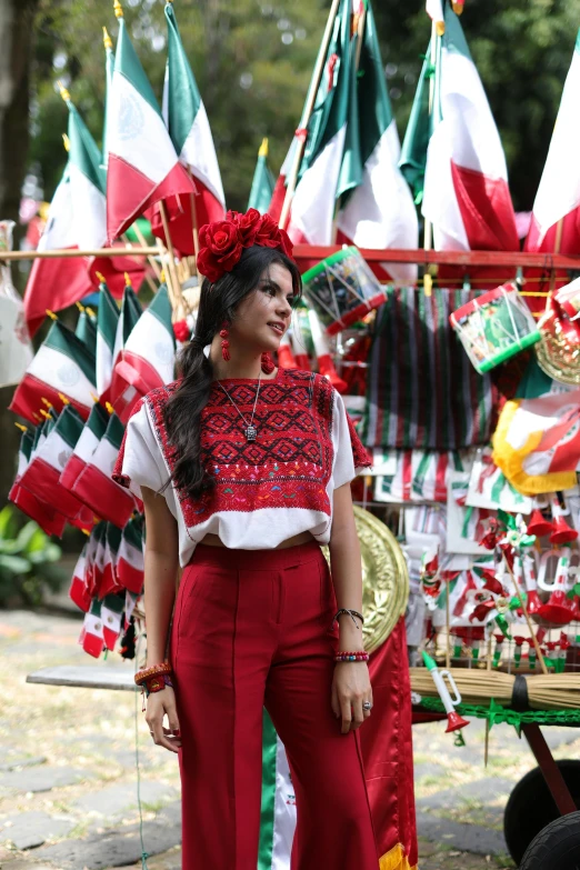 a woman is standing in front of colorful kites