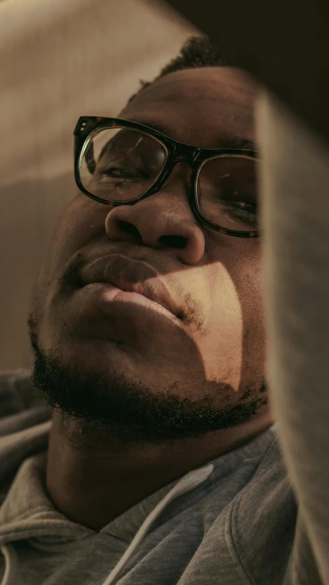 a man with glasses and a goatee, sitting