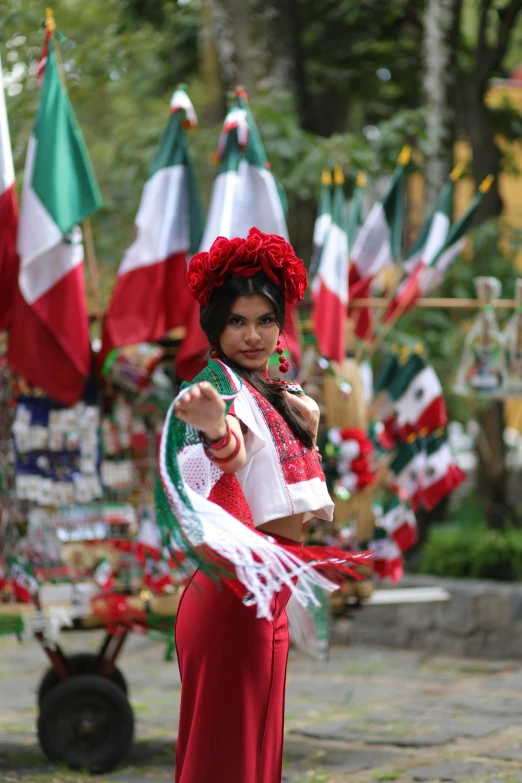 woman in traditional garb standing next to the italian flags