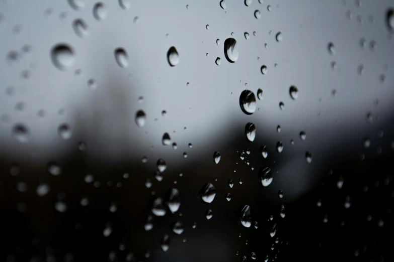 rain drops on window glass with a view of building