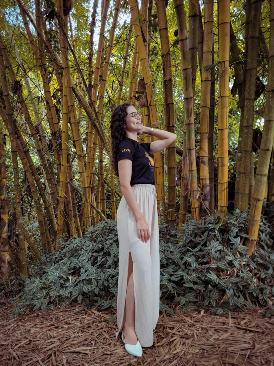 a person standing near trees looking up