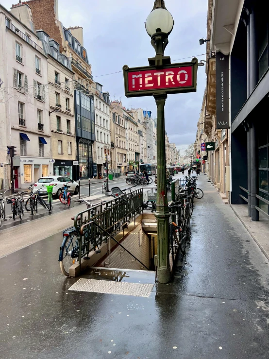 the view of bicycles parked on the sidewalk next to a street sign