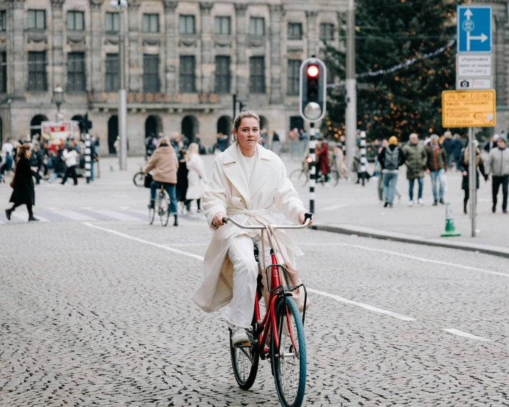 a woman on a bike with no pants riding in the street