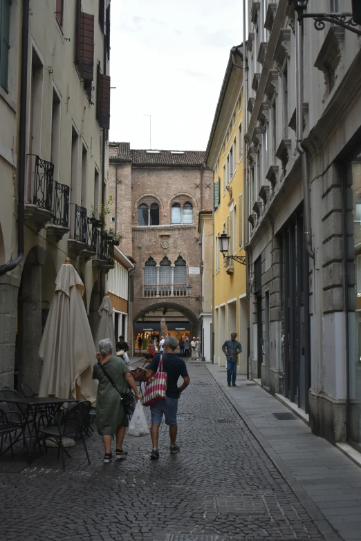 people walking through a street in a city