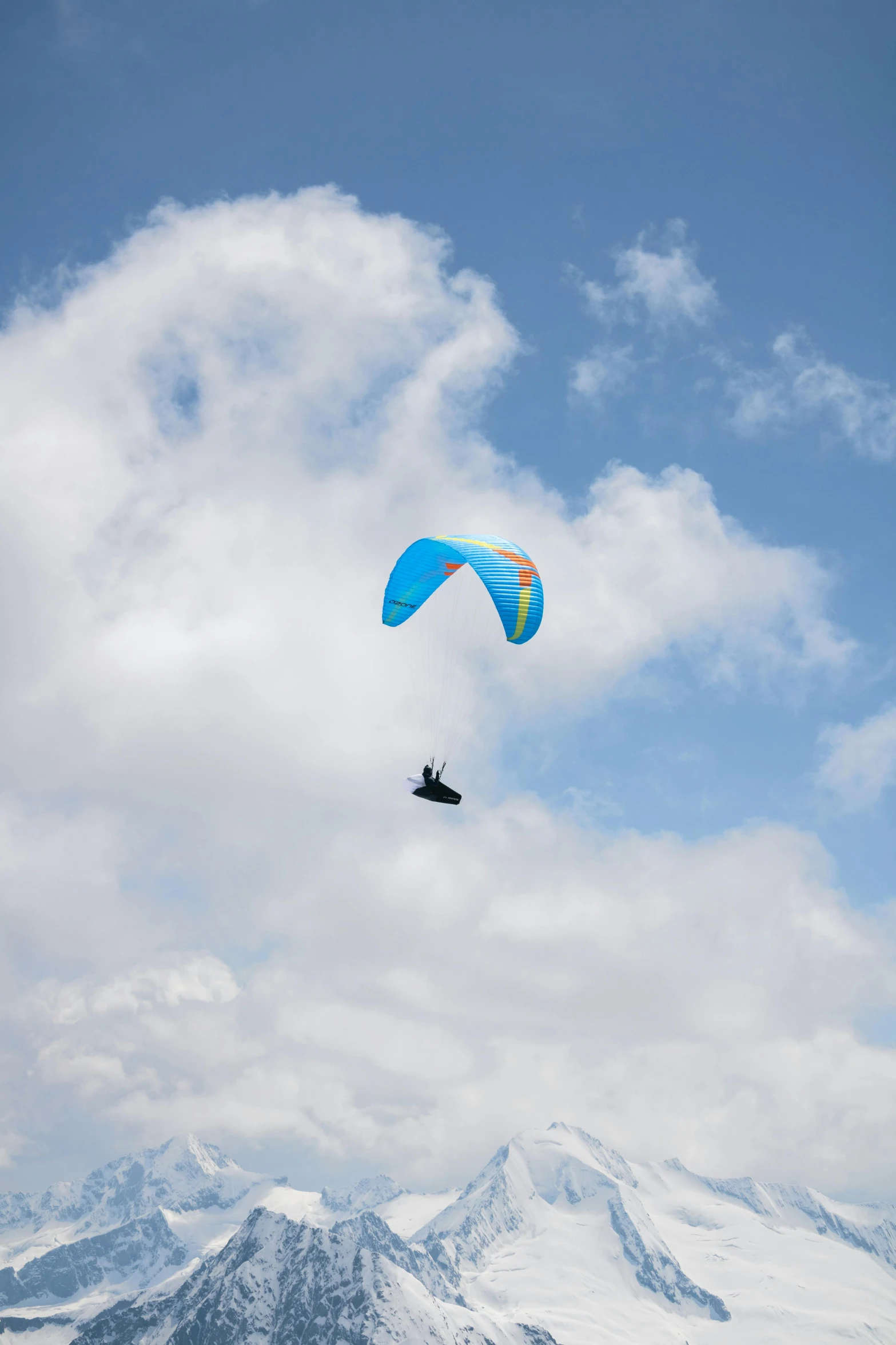 a person para - sailing in the mountains on a cloudy day