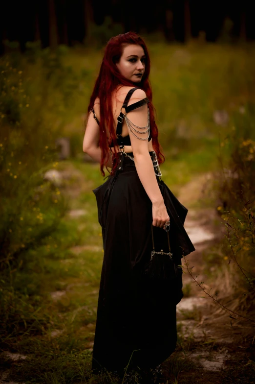 a red haired woman is holding a black bag