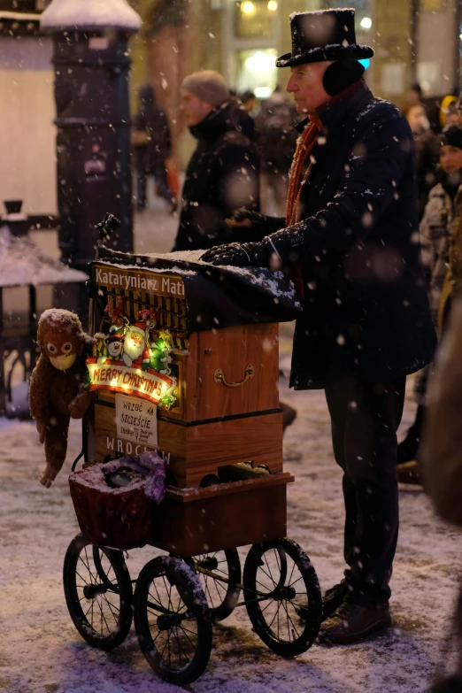 a man that is standing near a cart with items