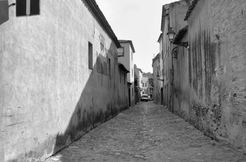 a black and white image of an alley