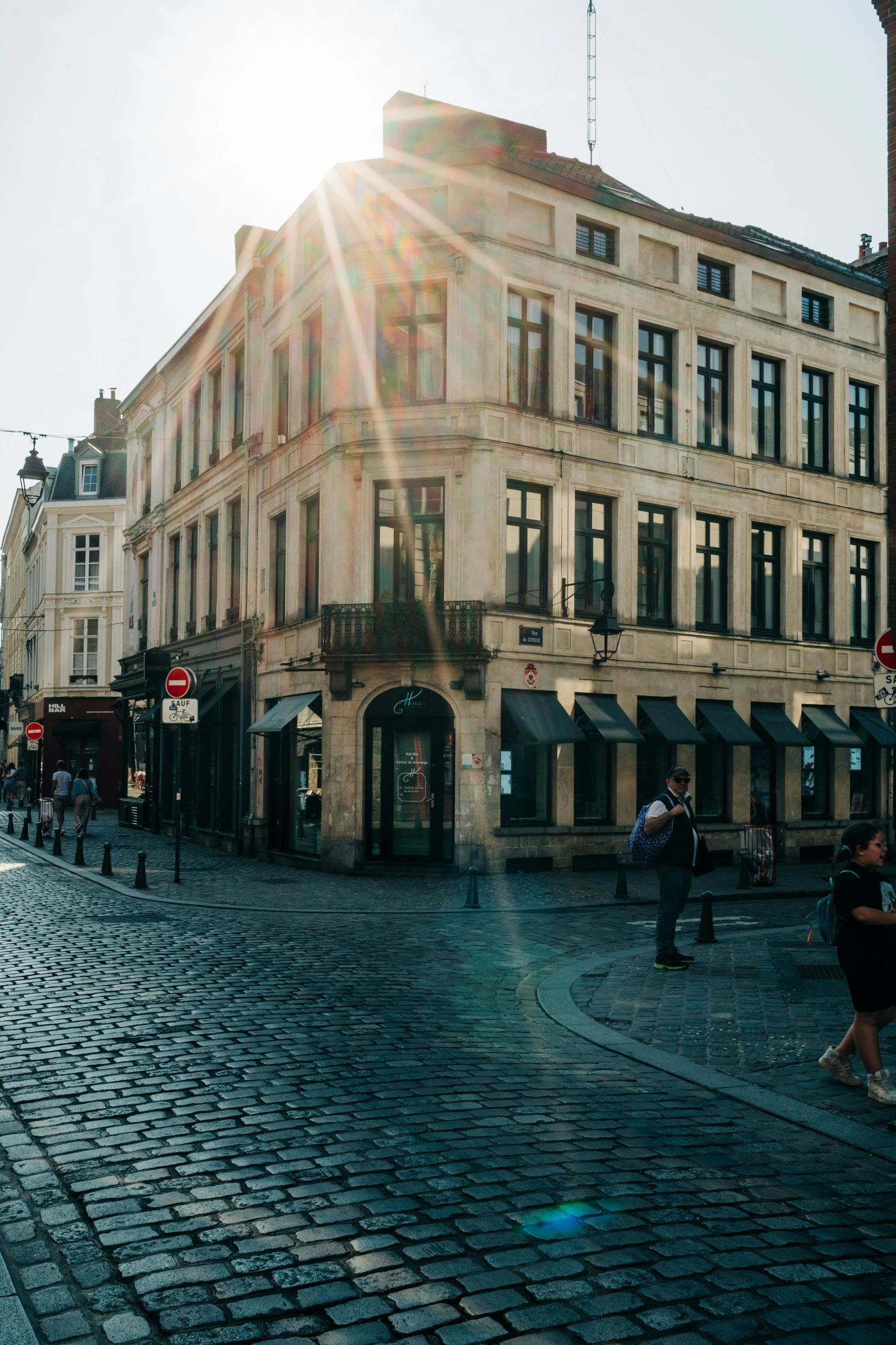 people are walking around on the cobblestone street