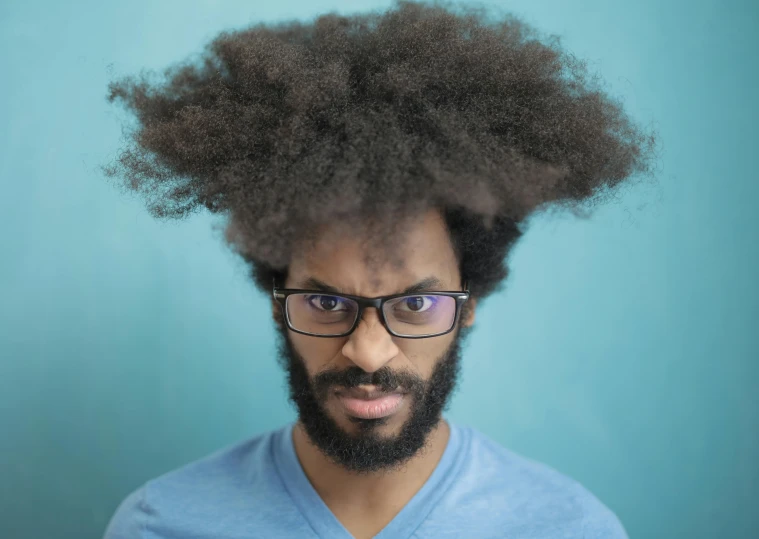 this man has his hair up into the shape of a afro