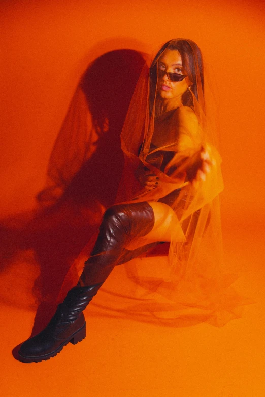 a woman wearing black and orange wearing leather
