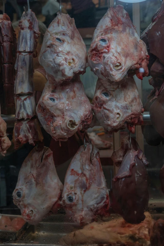 a man holding a knife in front of a bunch of cuts