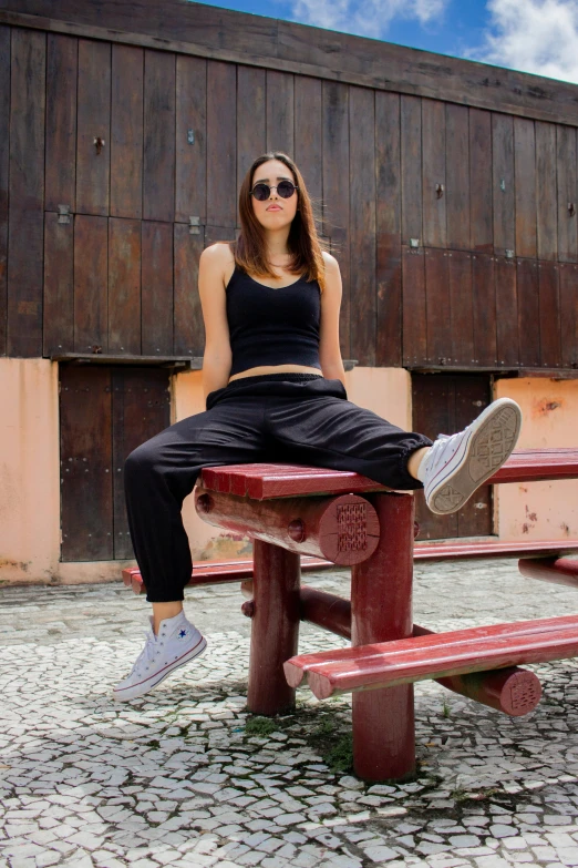 there is a young woman that is sitting on the bench