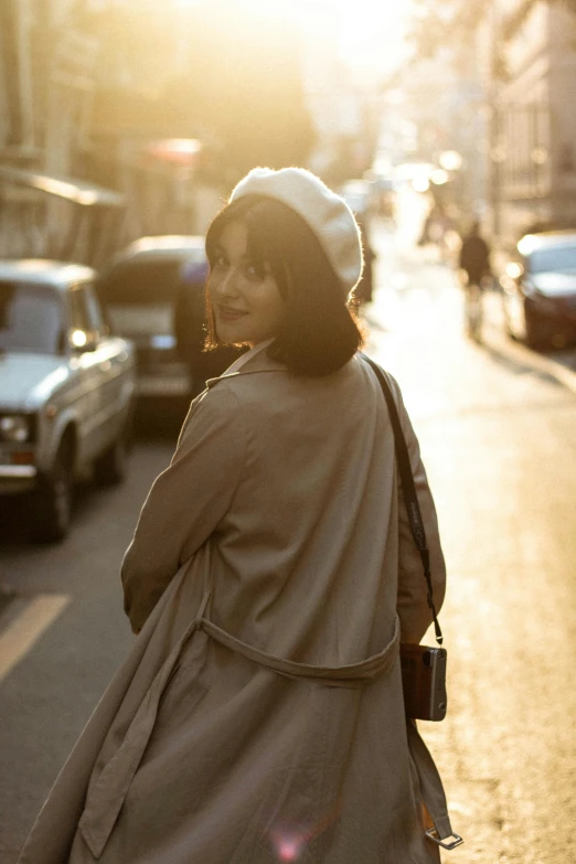 a woman is standing on the street during the day