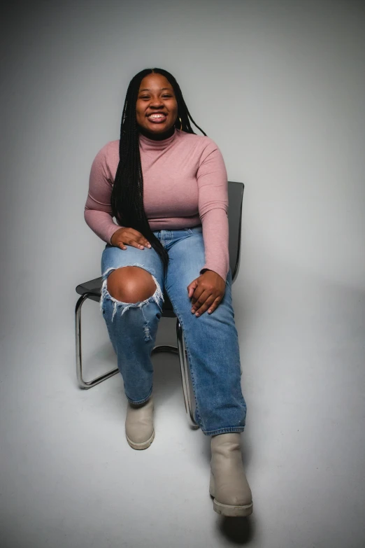 a woman is smiling and sitting in an office chair