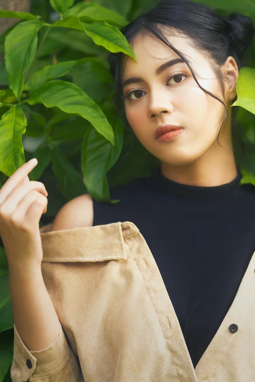 a woman standing in front of some plants