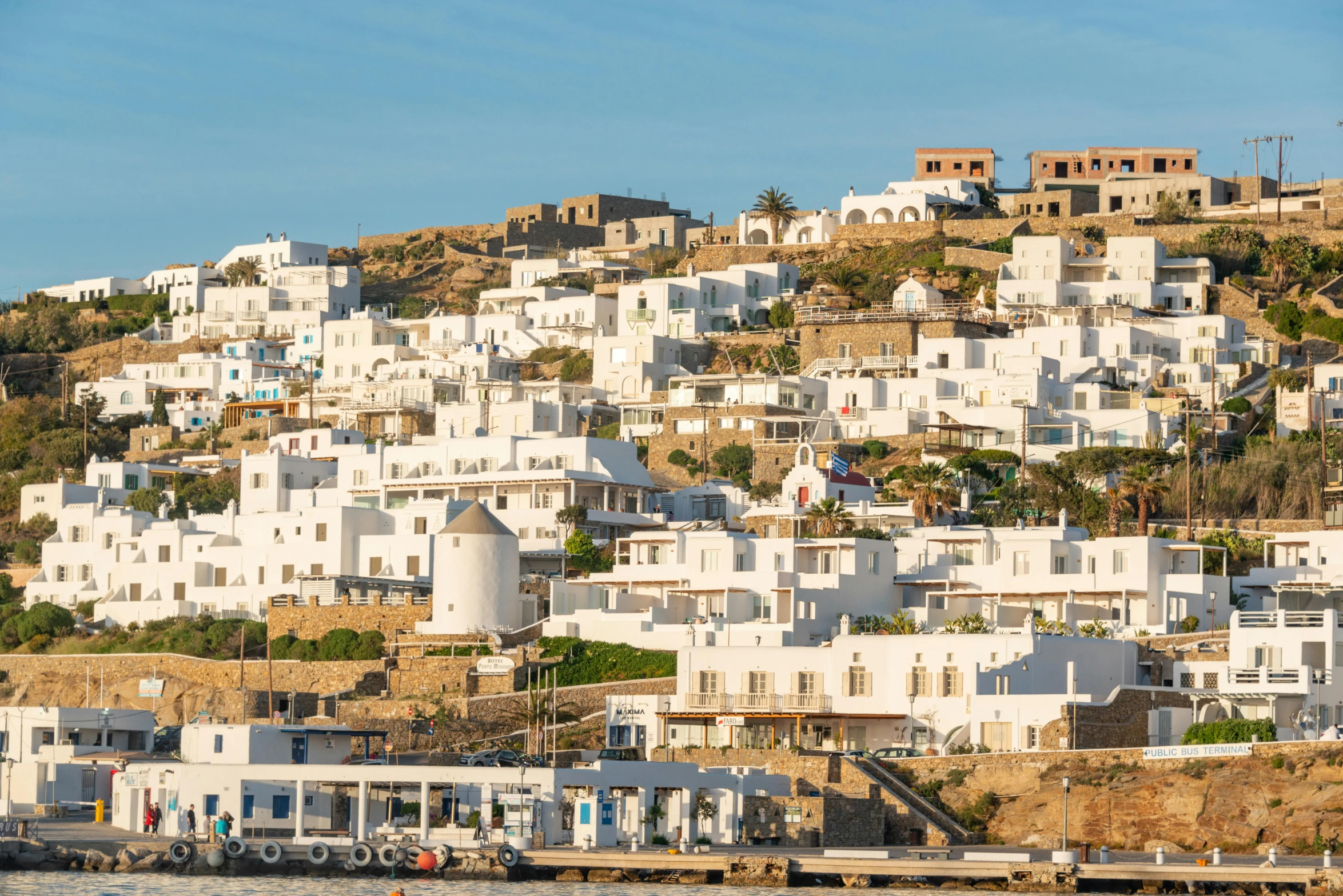 large white houses on top of a hill in a bay