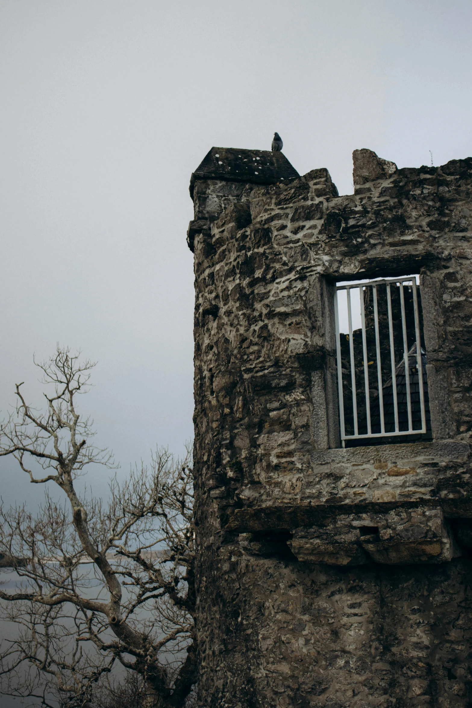 an old stone building with a window on it