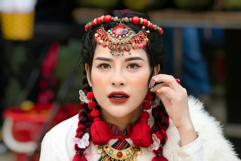 a woman in native costume holding up her hands