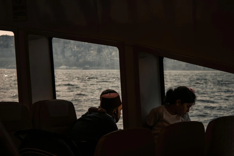 the two girls are looking out at the water