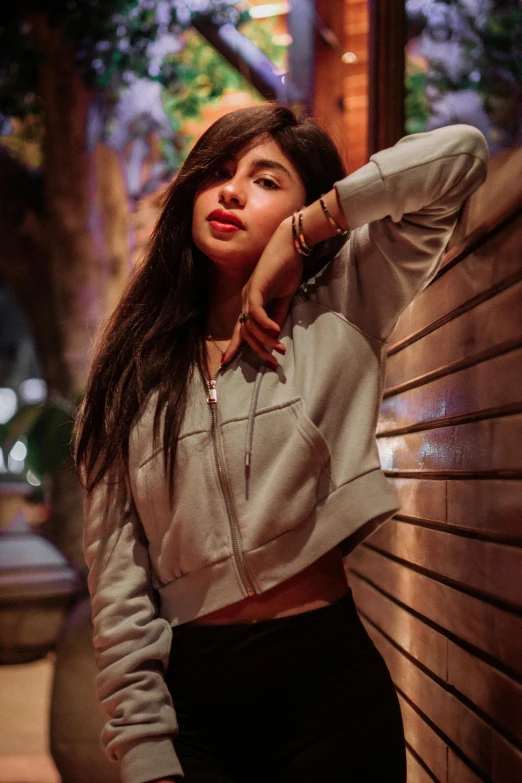 a woman leaning on a wooden bench in a building