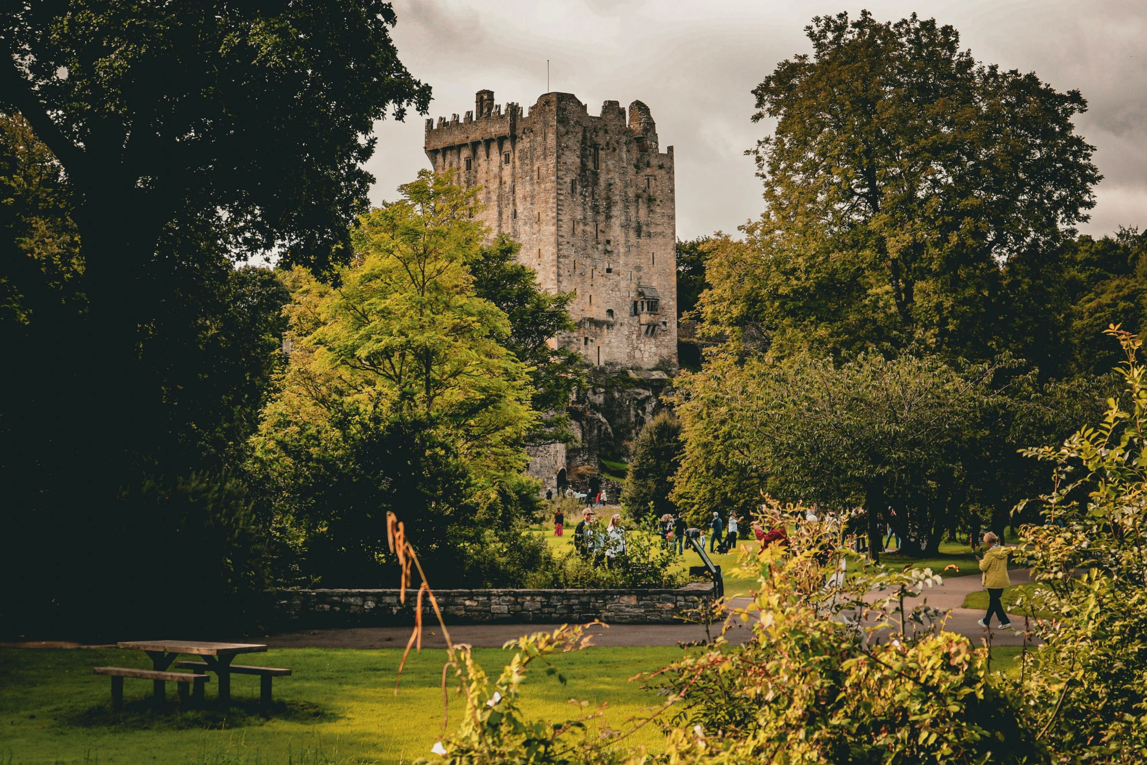 an area with a picnic table and a castle in the background