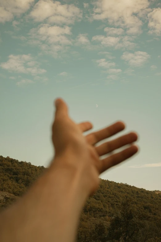 a hand that is reaching out towards a plane