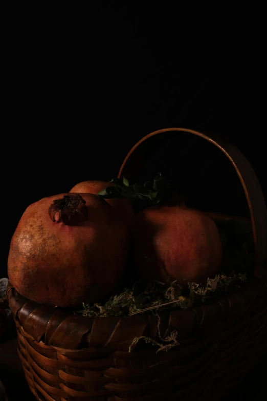 this is some pomegranate in a wicker basket