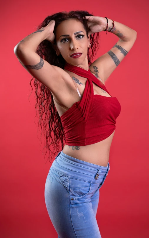 a women who is wearing some jeans and posing for the camera