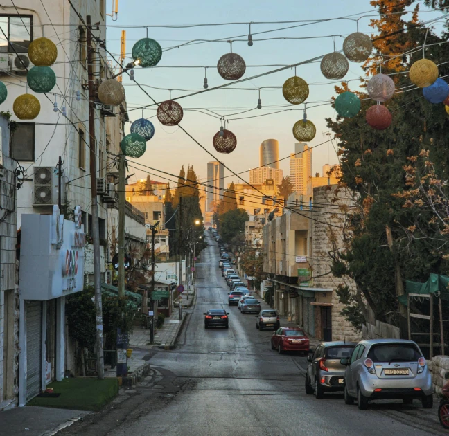 cars on a city street with lots of decorations