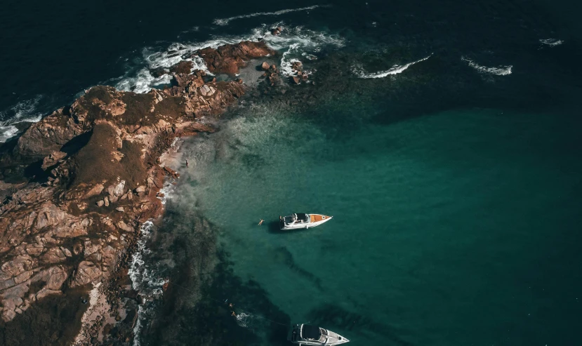 a white boat in a blue ocean water