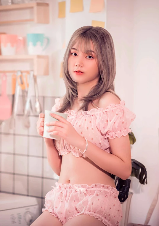 a girl wearing pink clothing holding a drink